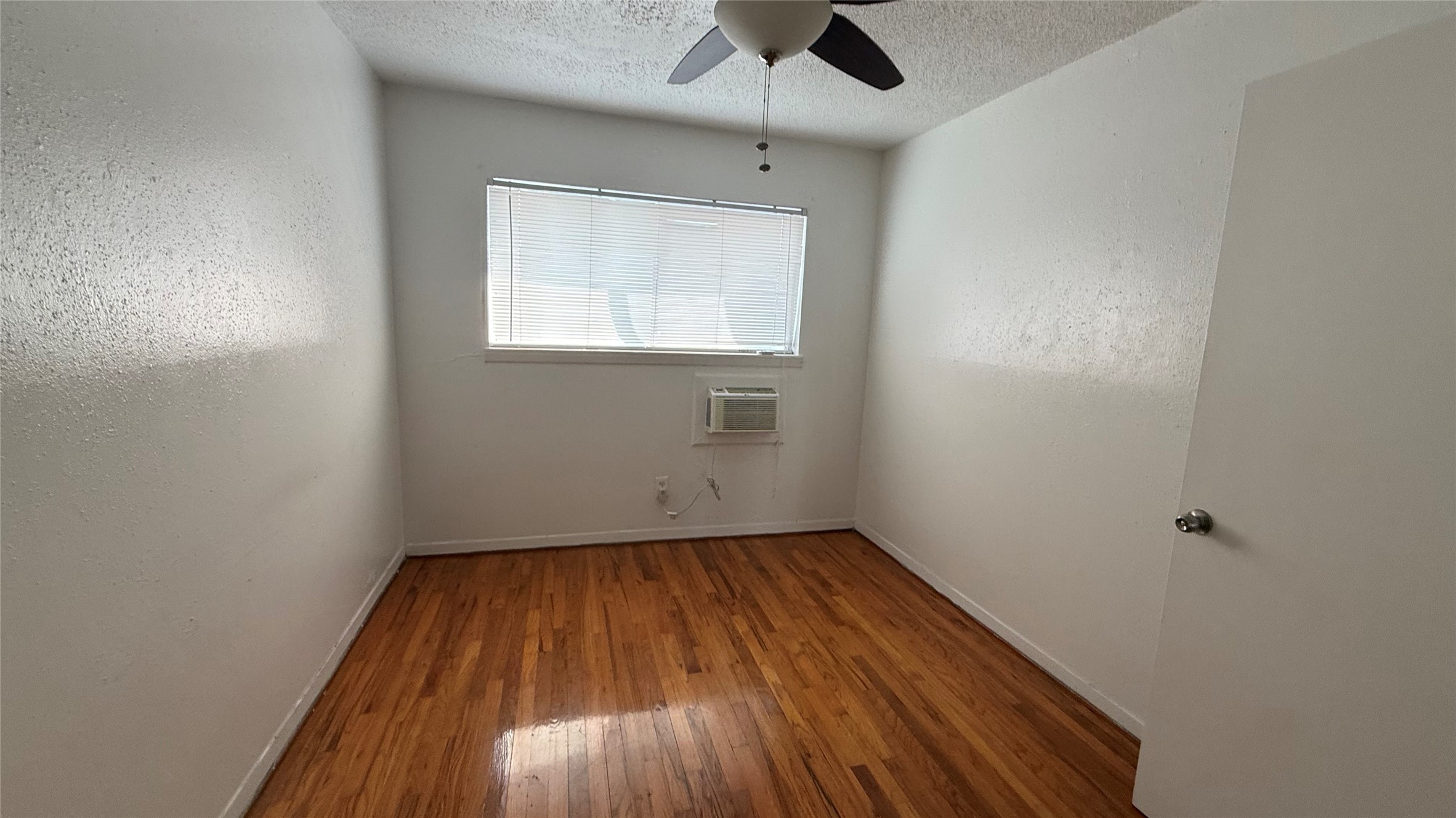 4921 Crawford Street, Unit 9 Houston, TX 77004 - Photo 7 of 9 an empty room with a window and a ceiling fan