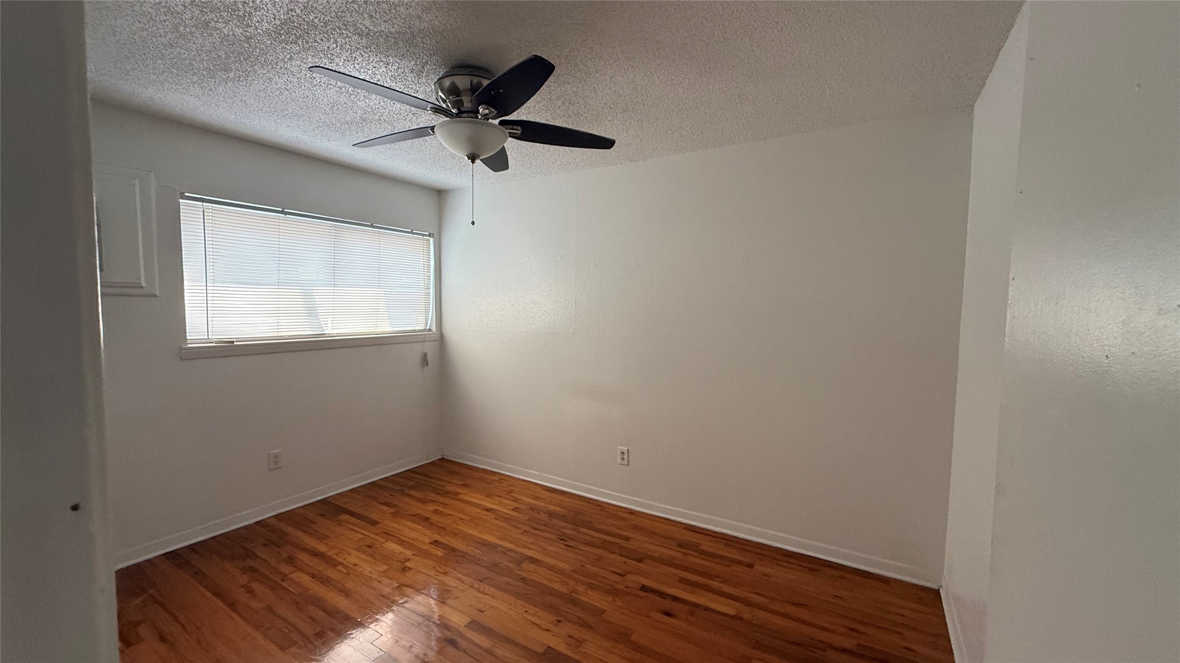 4921 Crawford Street, Unit 9 Houston, TX 77004 - Photo 8 of 9 a view of empty room with wooden floor and fan