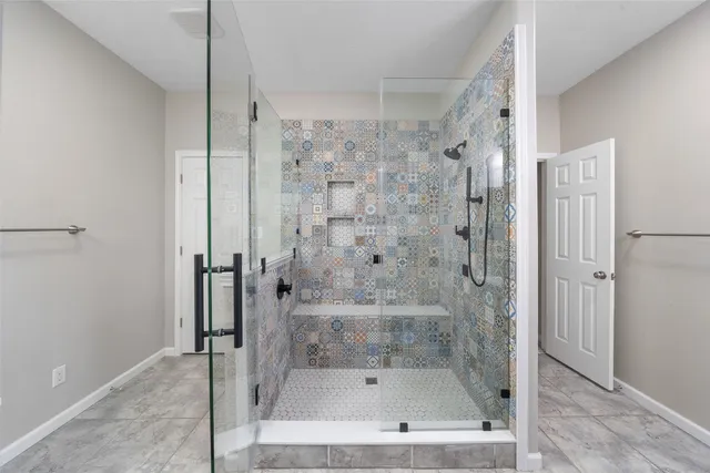 a bathroom with a bathtub and a shower