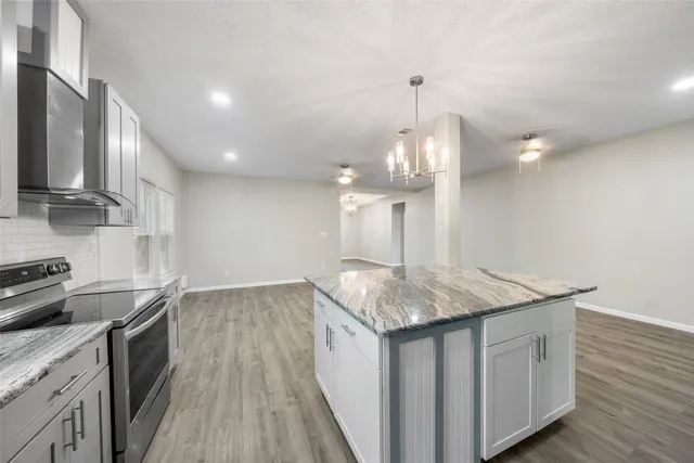 a kitchen with a sink a counter top space appliances and cabinets