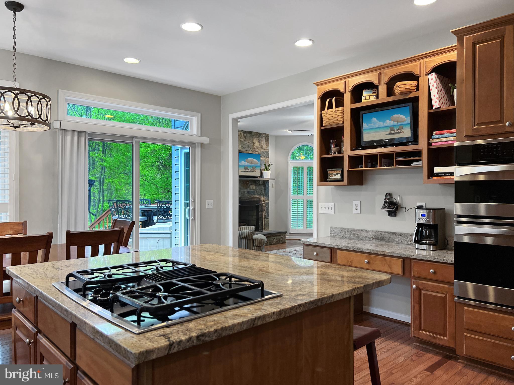 18210 Wickham Road Olney, MD 20832 - Photo 12 of 74 a kitchen with stainless steel appliances granite countertop a stove a sink and a microwave