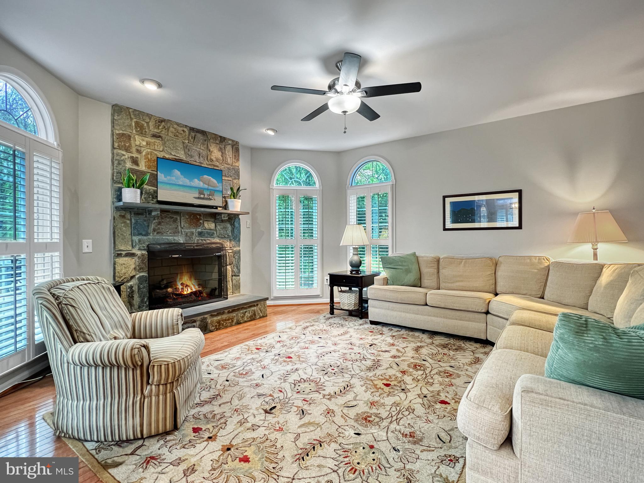18210 Wickham Road Olney, MD 20832 - Photo 14 of 74 a living room with furniture a flat screen tv and a fireplace