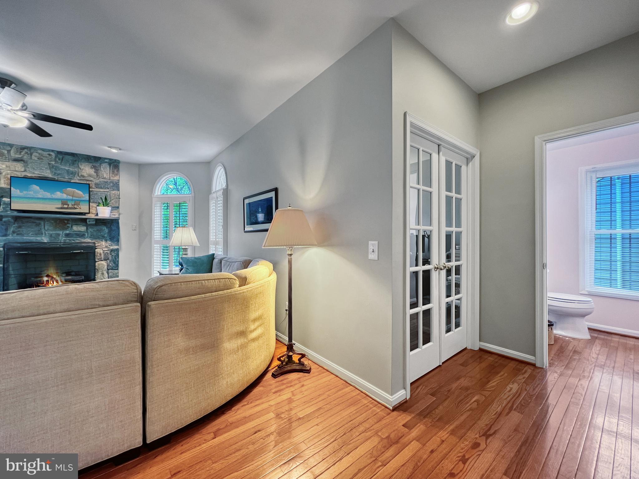 18210 Wickham Road Olney, MD 20832 - Photo 16 of 74 a living room with furniture and a fireplace