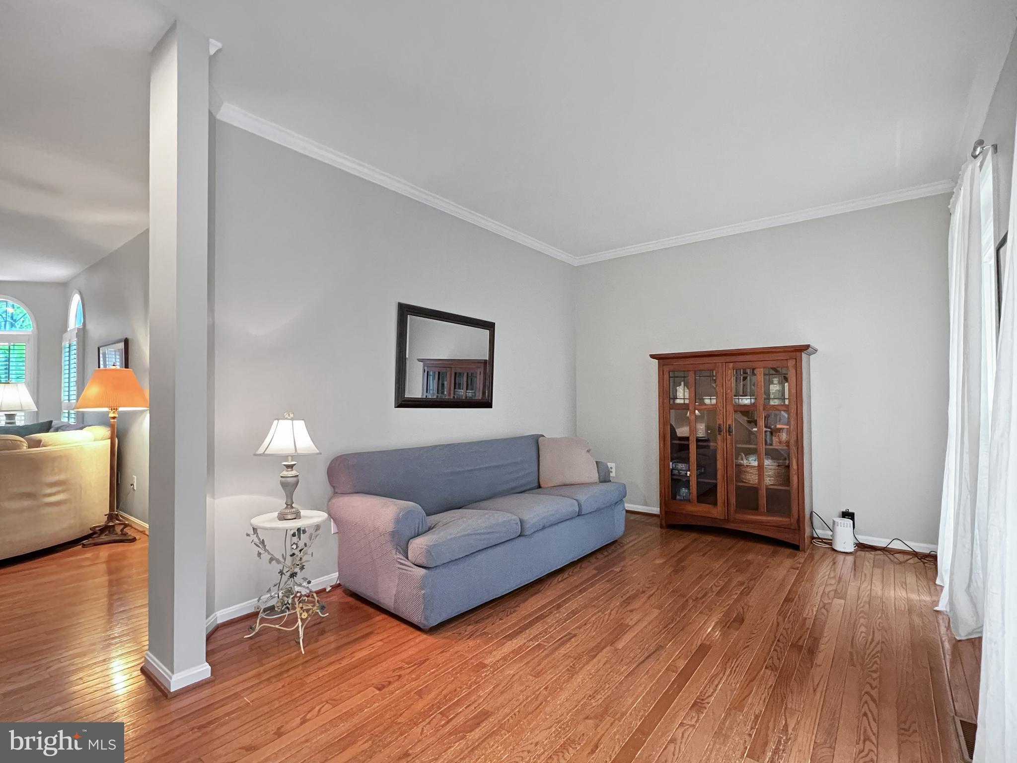 18210 Wickham Road Olney, MD 20832 - Photo 19 of 74 a living room with furniture and a wooden floor