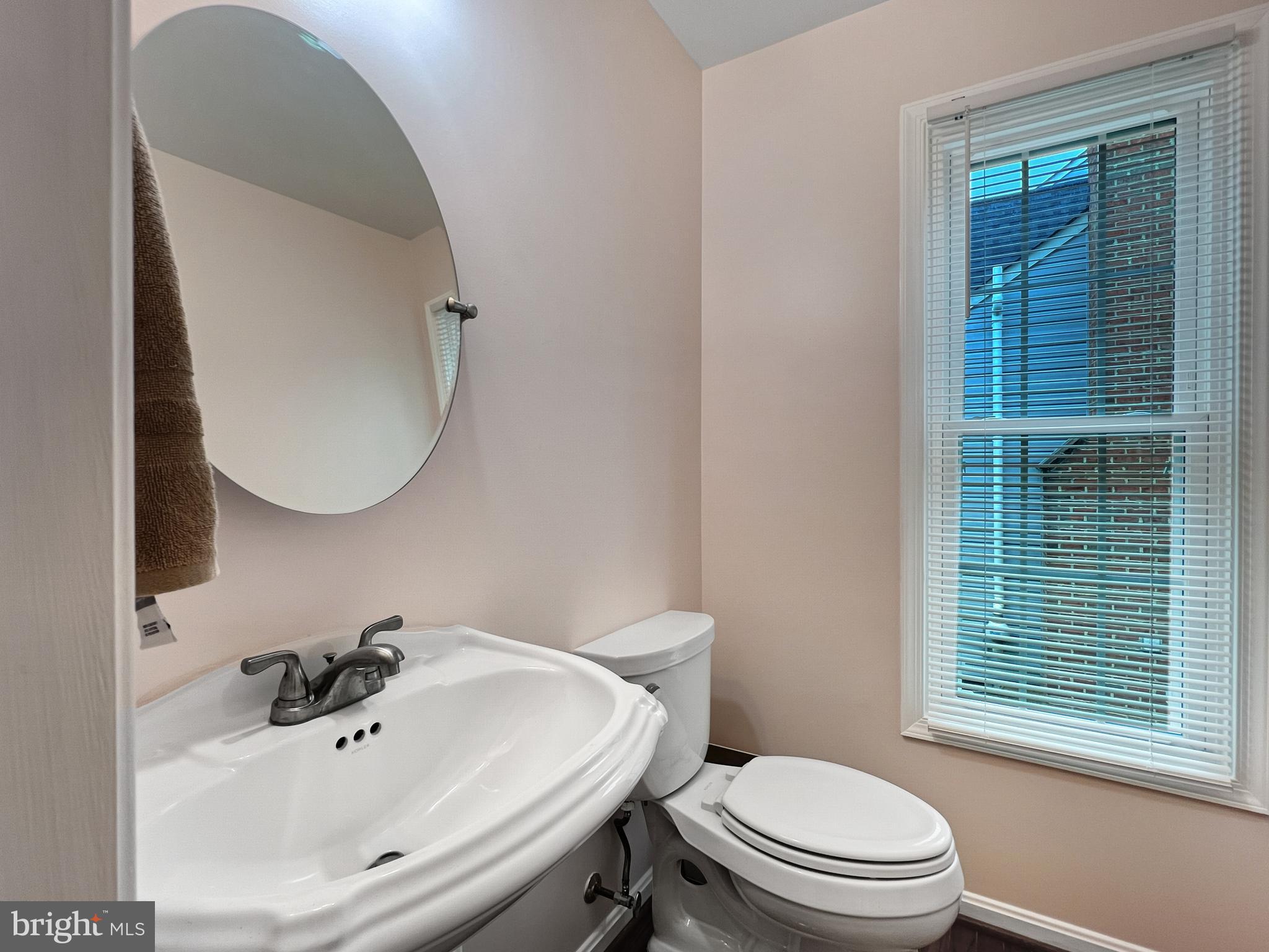 18210 Wickham Road Olney, MD 20832 - Photo 20 of 74 a bathroom with a sink a toilet and a mirror