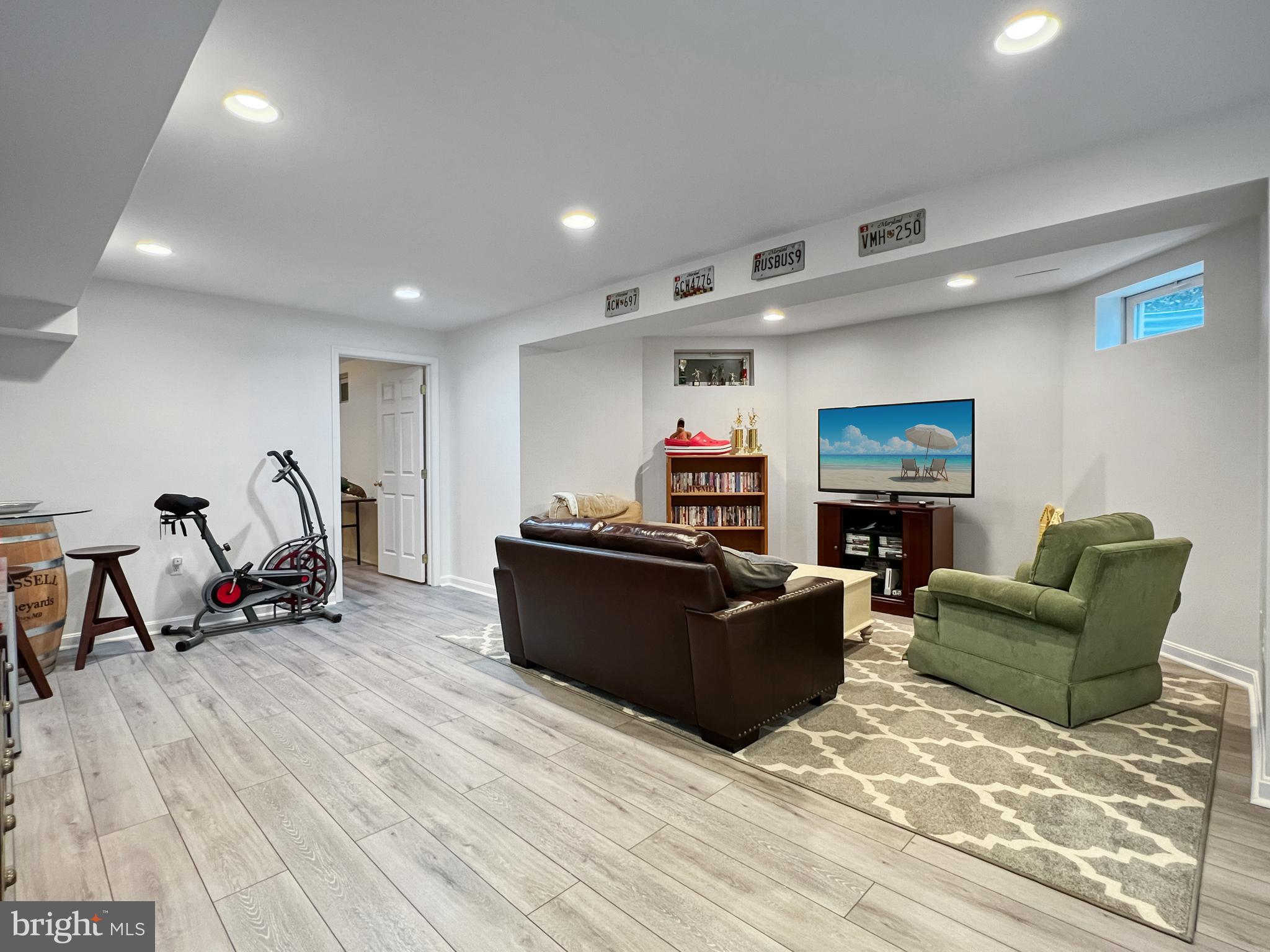 18210 Wickham Road Olney, MD 20832 - Photo 44 of 74 a living room with furniture and a wooden floor