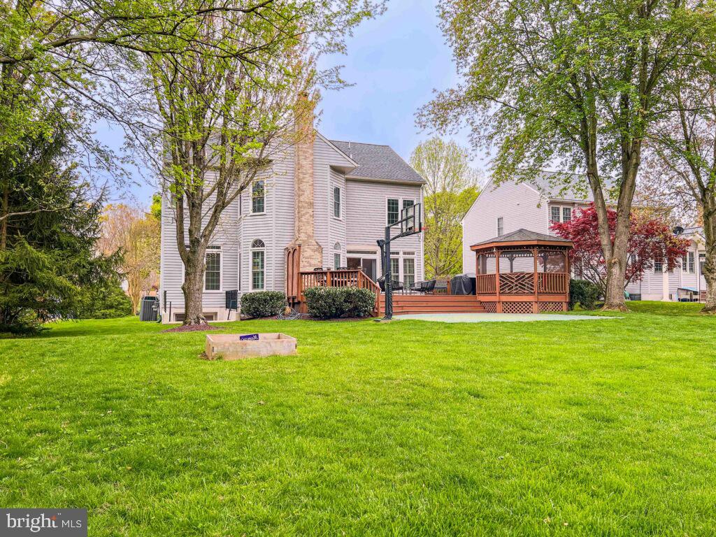 18210 Wickham Road Olney, MD 20832 - Photo 55 of 74 a front view of a house with garden and trees