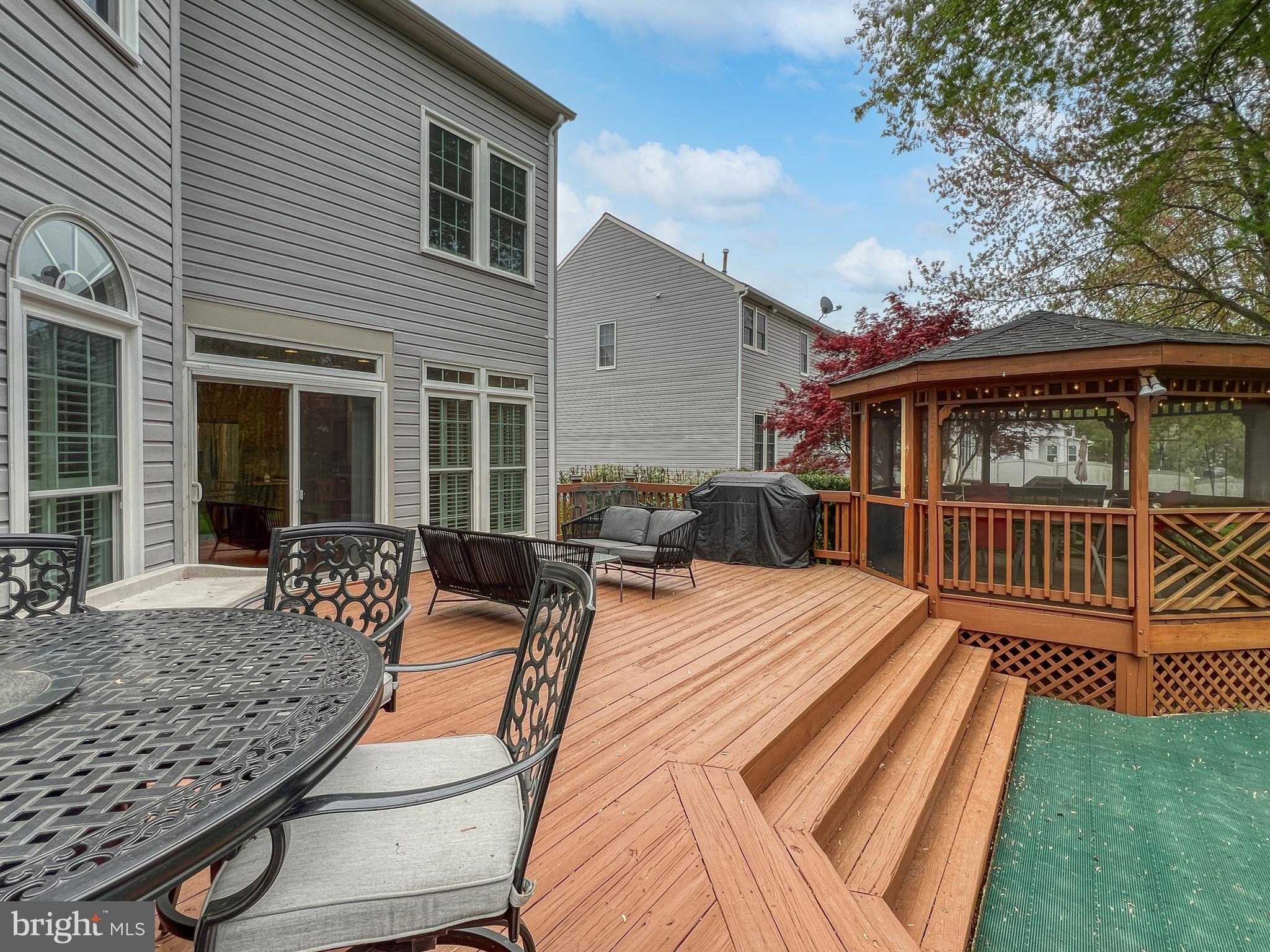 18210 Wickham Road Olney, MD 20832 - Photo 60 of 74 a view of a house with wooden deck outdoor seating