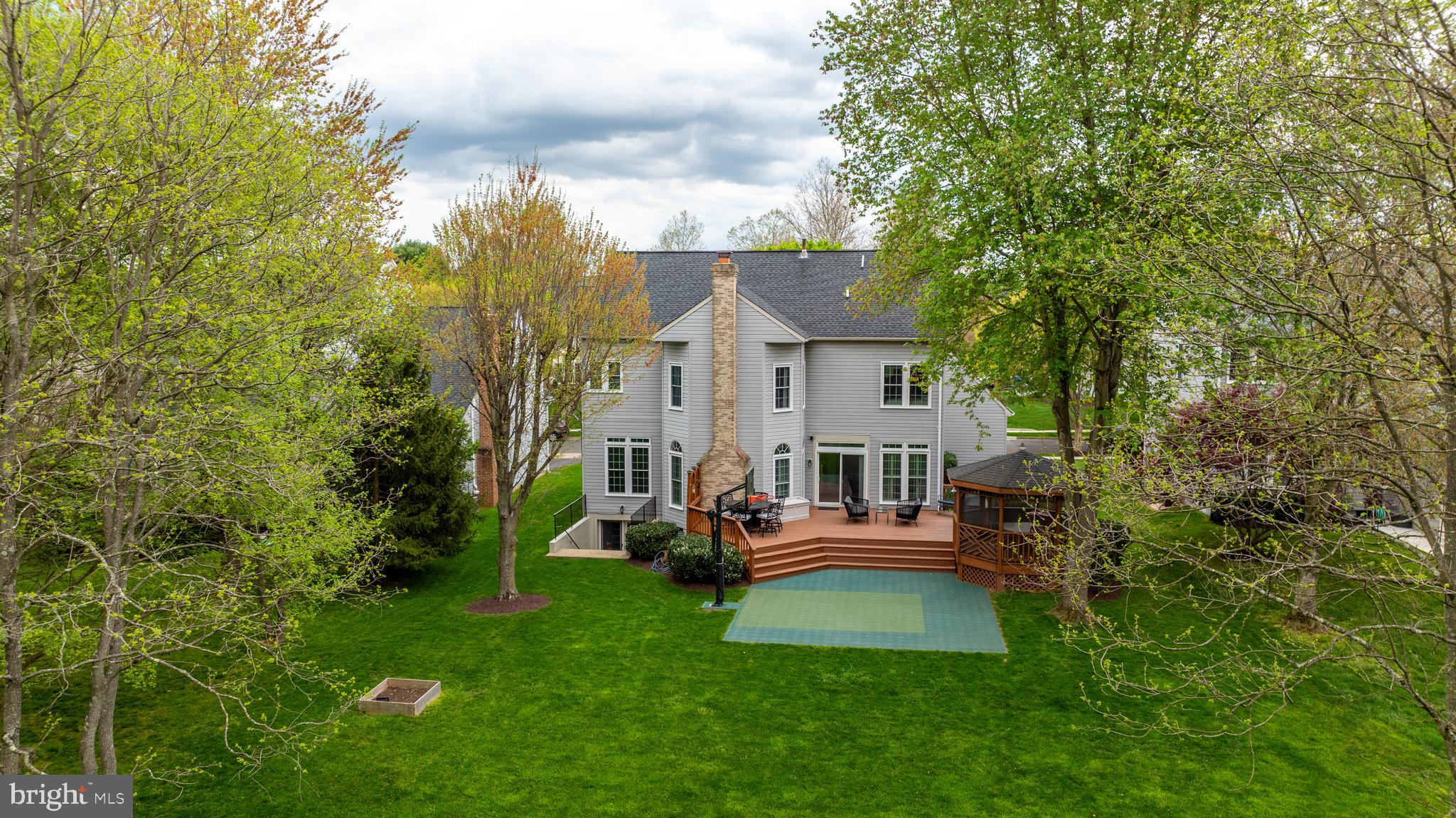 18210 Wickham Road Olney, MD 20832 - Photo 6 of 74 a view of a house with a backyard and sitting area
