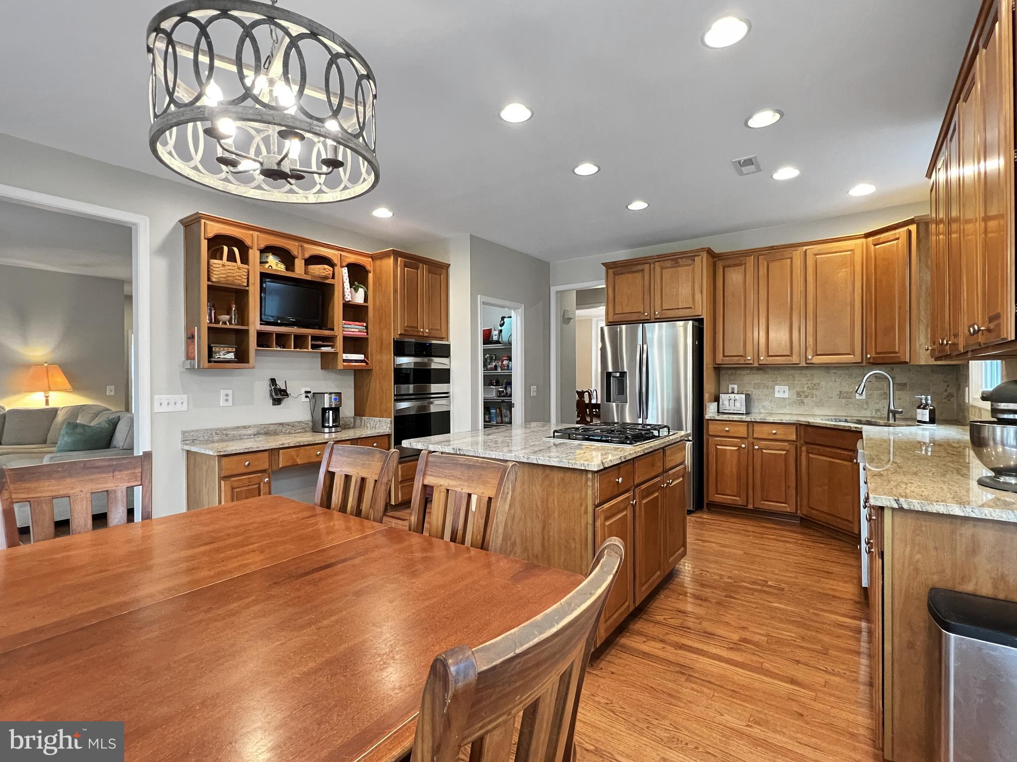 18210 Wickham Road Olney, MD 20832 - Photo 10 of 74 a large kitchen with stainless steel appliances wooden floor and a refrigerator