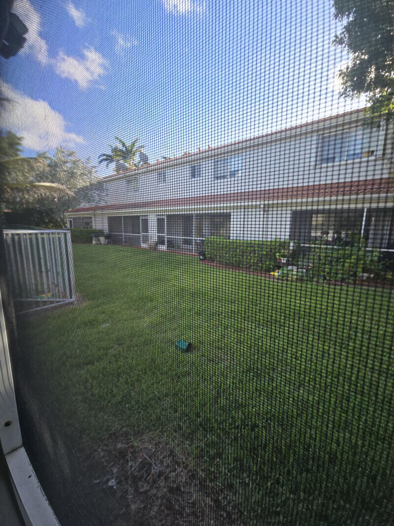 6511 Sandy Bank Terrace Riviera Beach, FL 33407 - Photo 4 of 12 a view of a house with a backyard