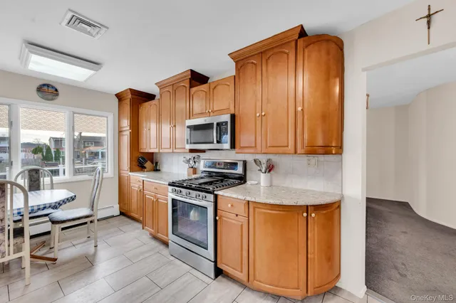a kitchen with stainless steel appliances granite countertop a stove a sink and a refrigerator