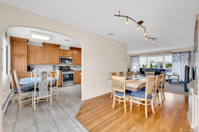 a view of a dining room with furniture and wooden floor