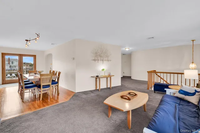 a living room with furniture a rug and a table