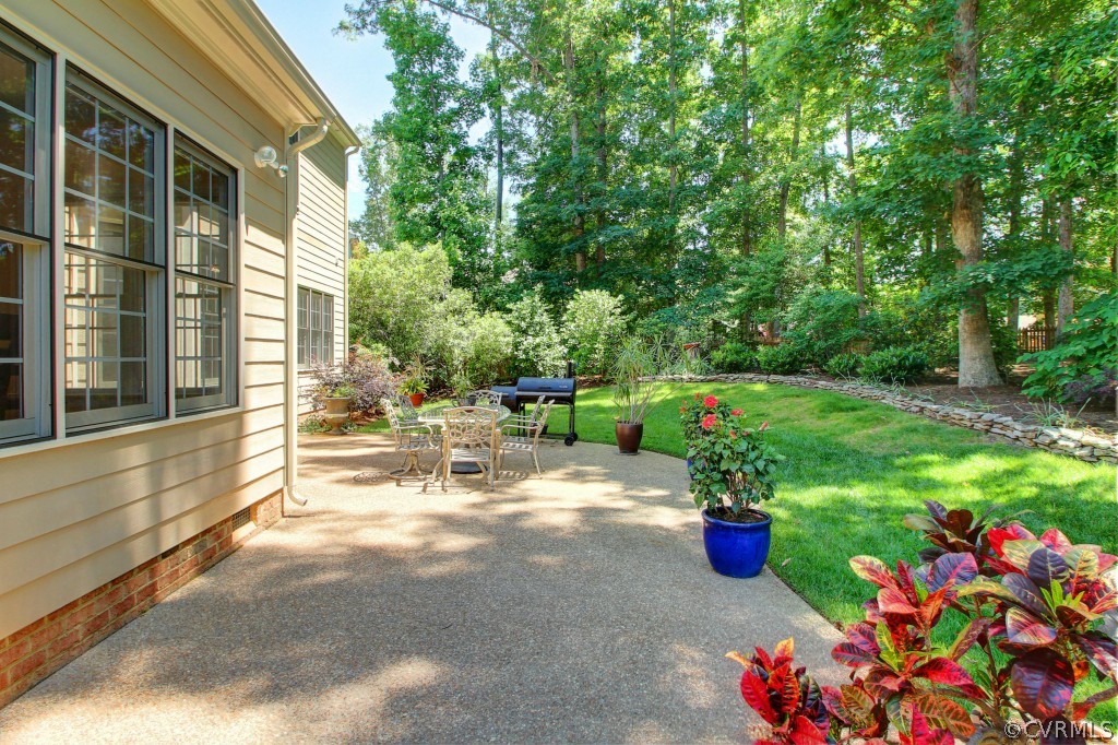 13336 Tipple Point Road Midlothian, VA 23114 - Photo 19 of 24 a view of a chair and tables in the back yard of the house