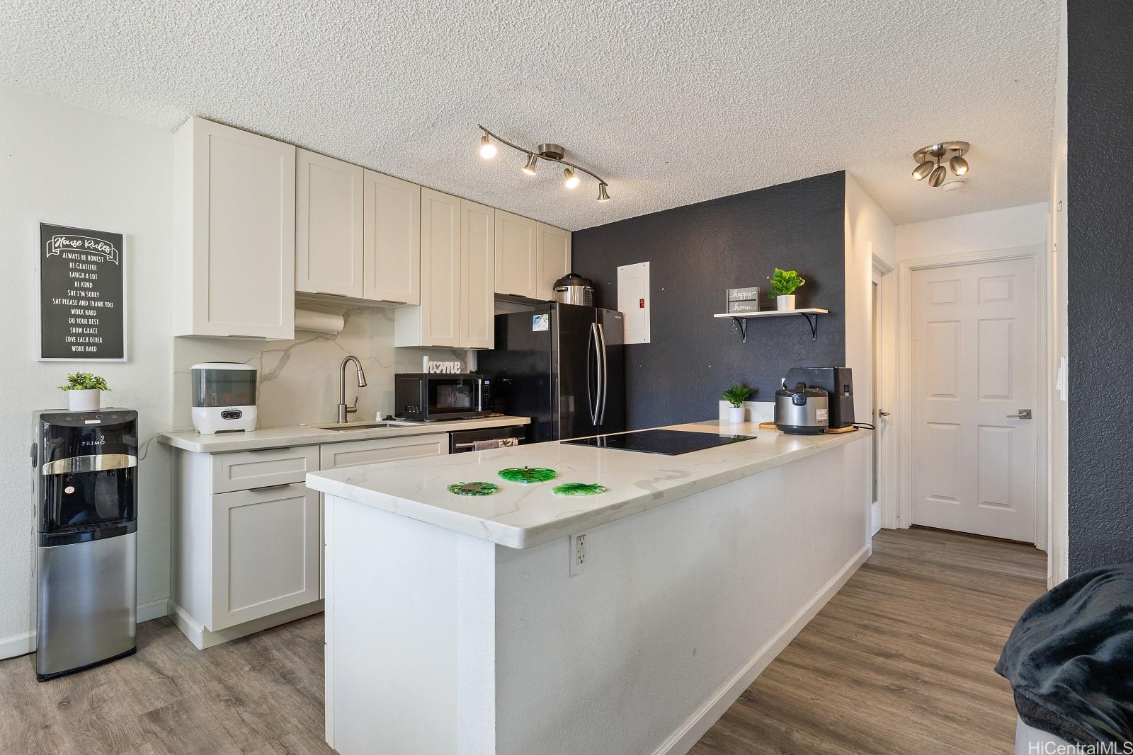 a kitchen with cabinets a sink and white appliances