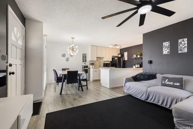 a living room with furniture and a chandelier