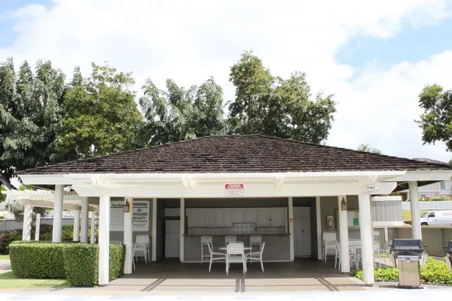a front view of a building with glass windows and table