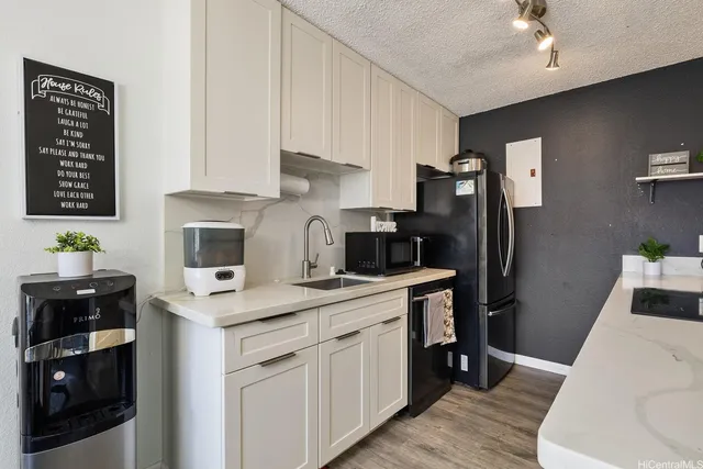a kitchen with a sink cabinets and stainless steel appliances