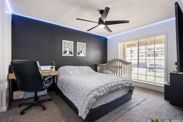 a bedroom with a bed and a large window