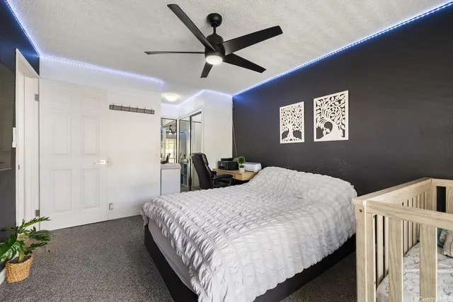 a bedroom with a bed and a ceiling fan