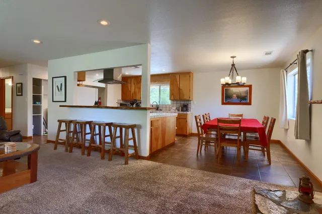 a dining room with furniture and wooden floor