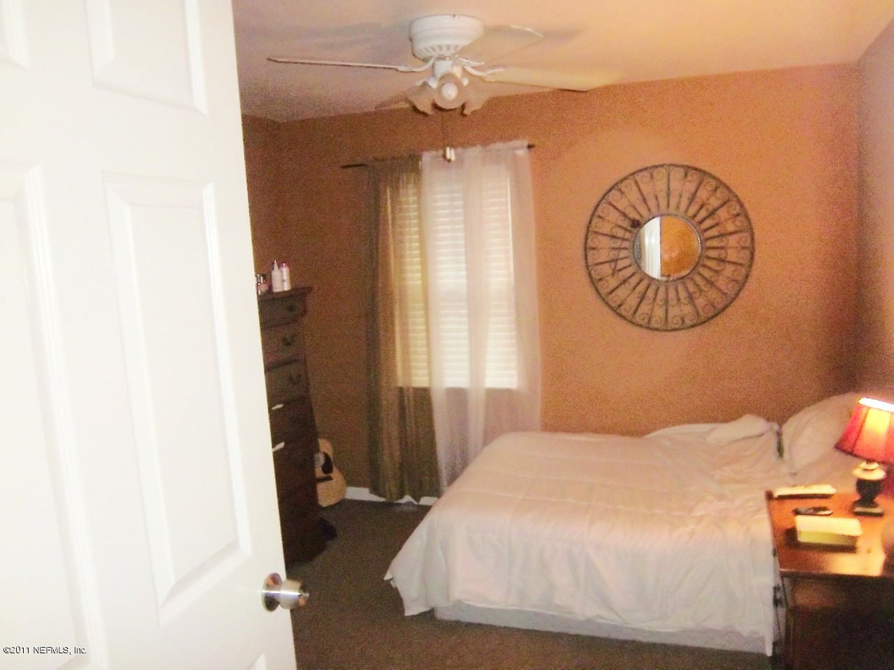 2771 Pellicer Road St. Augustine, FL 32092 - Photo 16 of 22 a bedroom with a bed and a chandelier