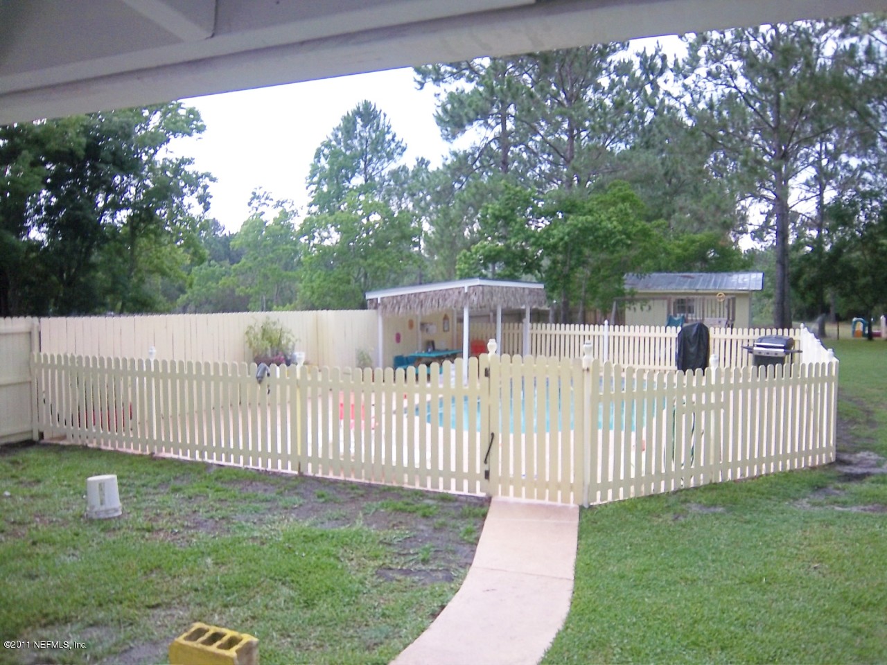 2771 Pellicer Road St. Augustine, FL 32092 - Photo 19 of 22 a view of a white house in a yard with wooden fence