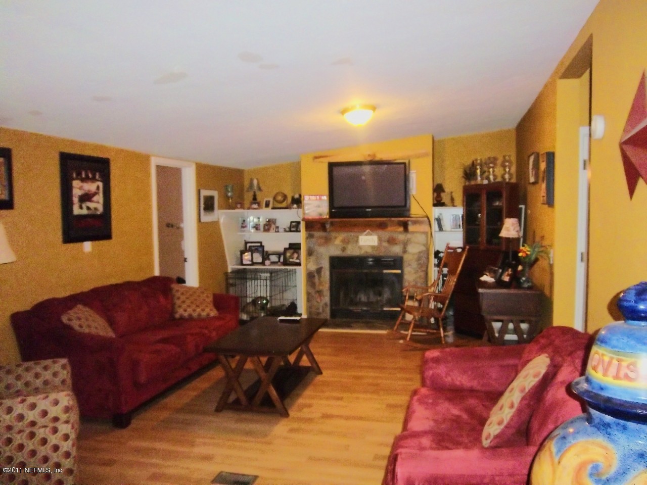 2771 Pellicer Road St. Augustine, FL 32092 - Photo 8 of 22 a living room with furniture a flat screen tv and a fireplace