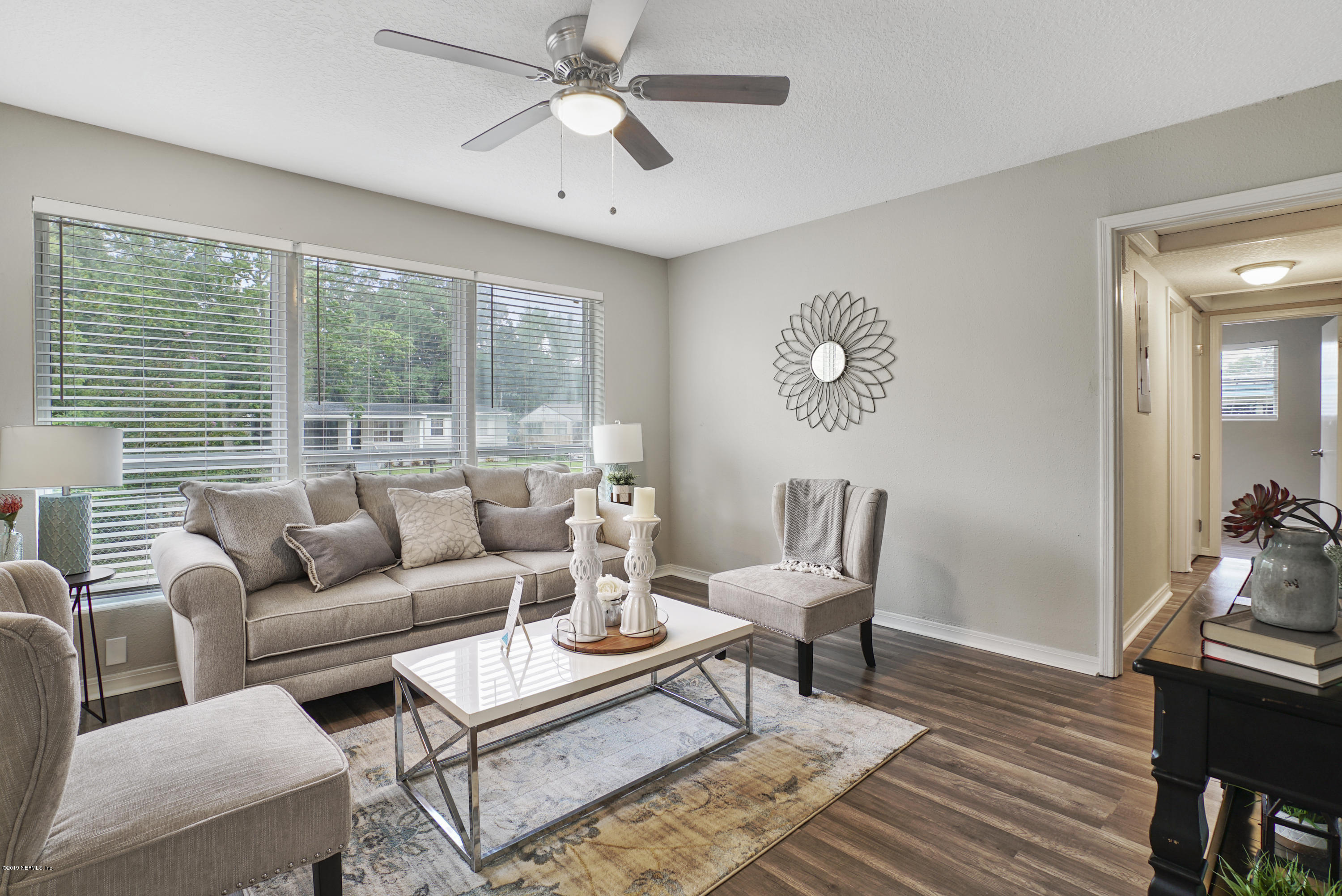10506 Briarcliff Road South Jacksonville, FL 32218 - Photo 1 of 14 a living room with furniture a table and a large window