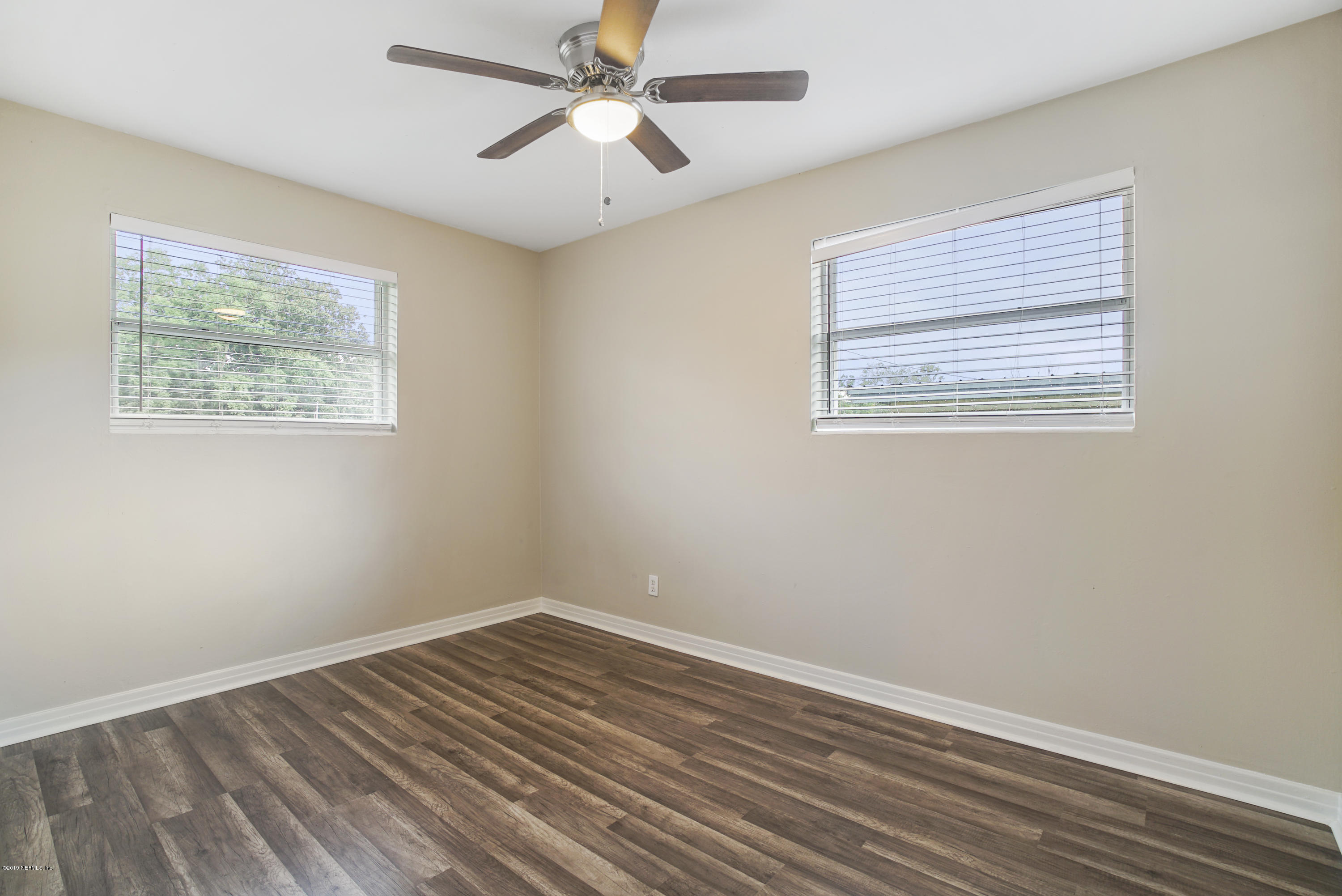 10506 Briarcliff Road South Jacksonville, FL 32218 - Photo 8 of 14 a view of an empty room with wooden floor and a window