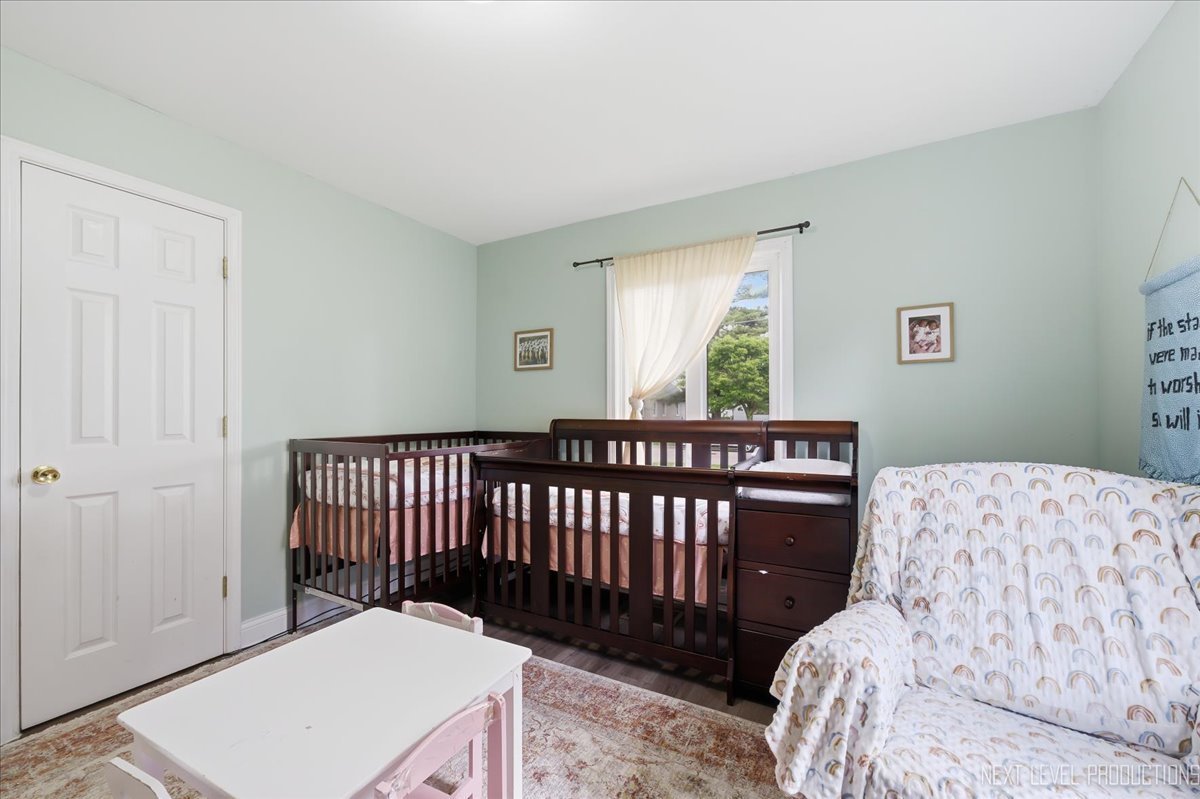 138 North Calhoun Street Aurora, IL 60505 - Photo 13 of 24 a bedroom with a bed and a window