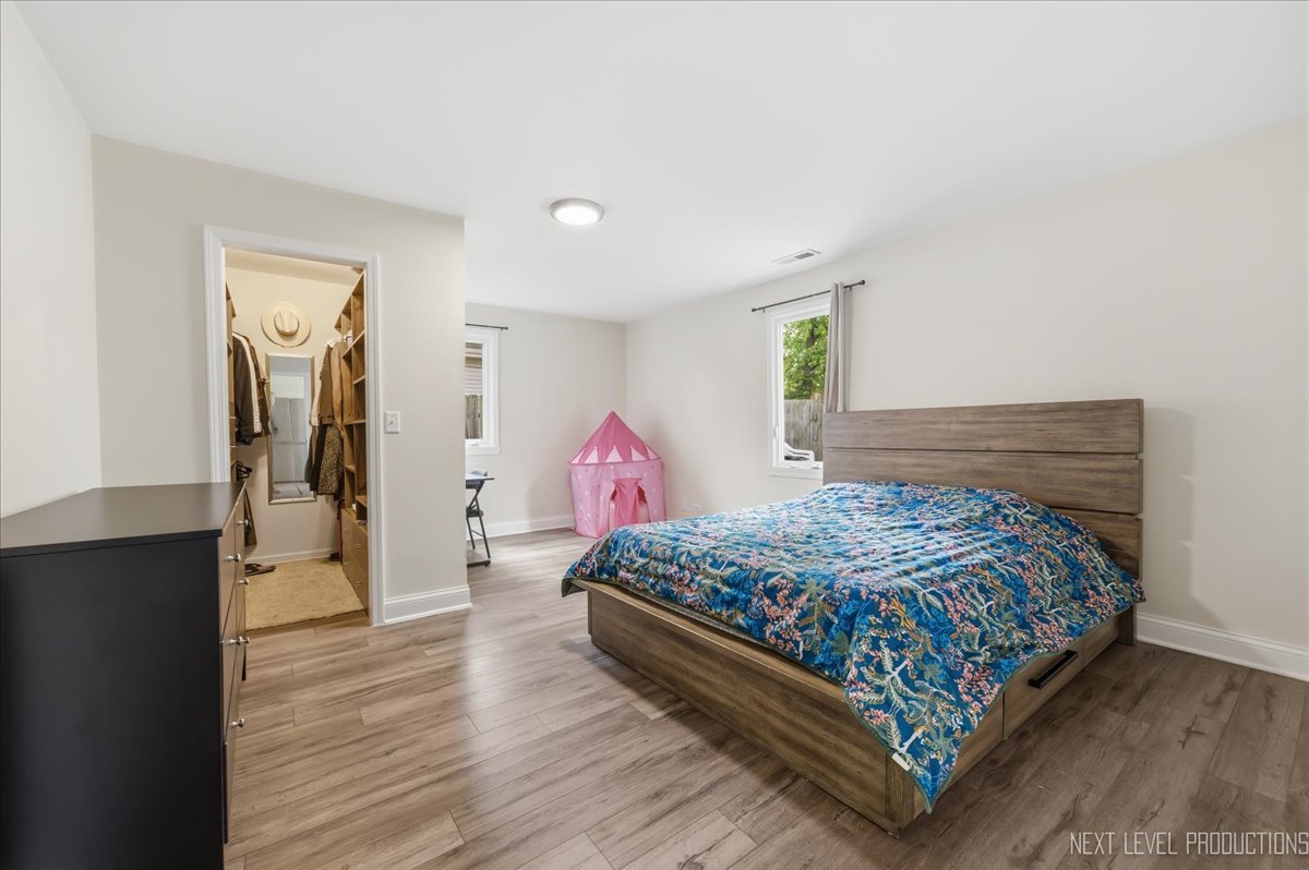 138 North Calhoun Street Aurora, IL 60505 - Photo 17 of 24 a bedroom with a bed and a dresser