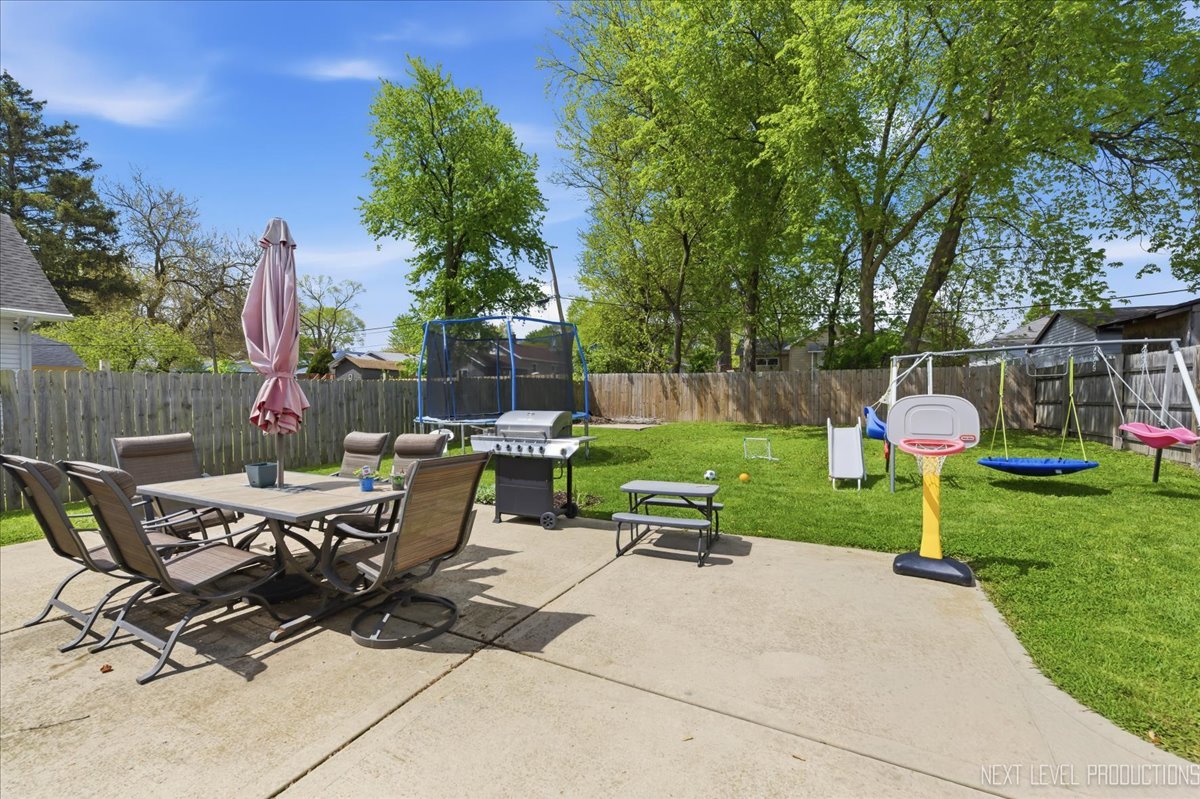 138 North Calhoun Street Aurora, IL 60505 - Photo 20 of 24 a view of a patio with a table chairs and a slide