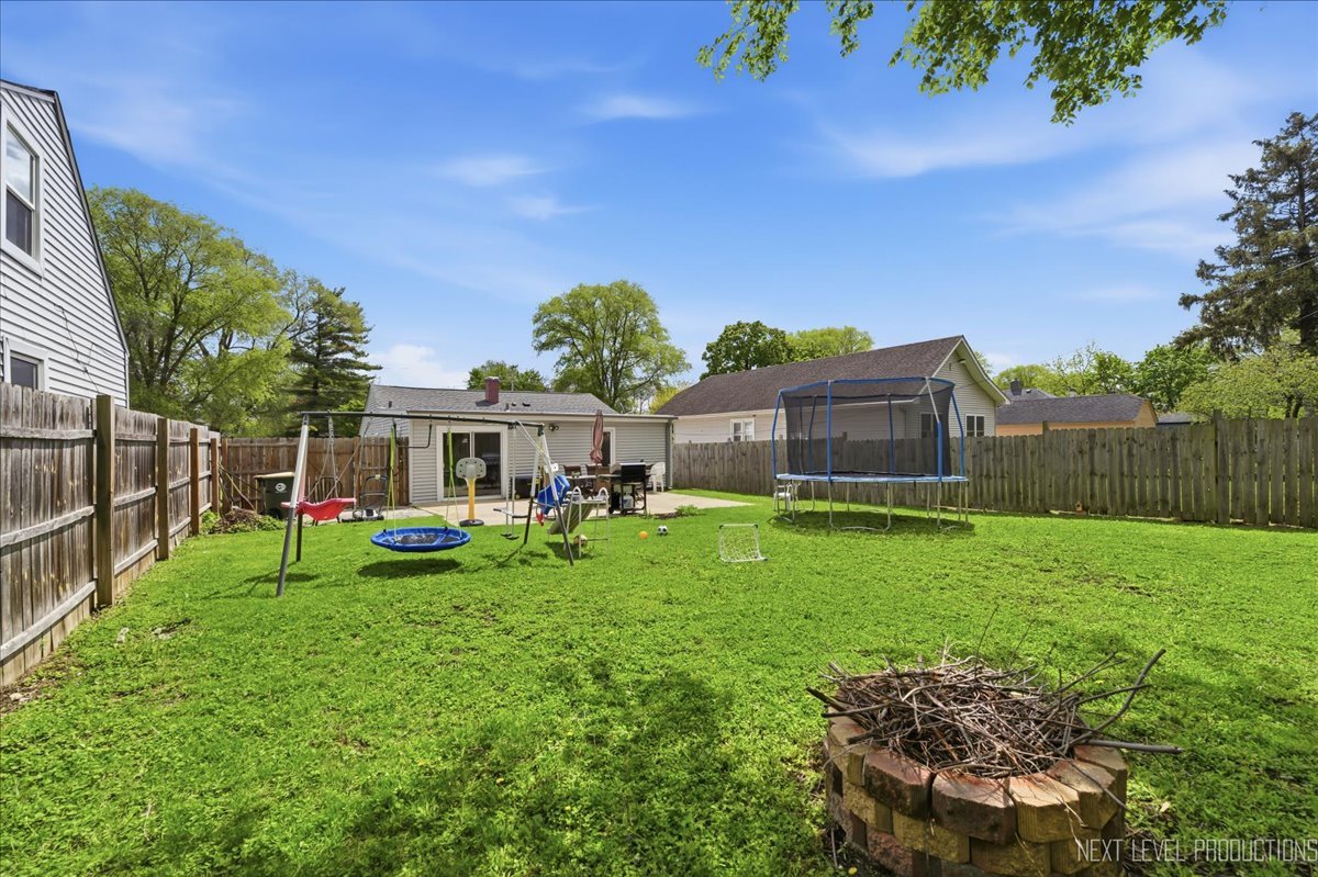 138 North Calhoun Street Aurora, IL 60505 - Photo 23 of 24 a view of backyard with table and chairs and potted plants and covered with wooden fence