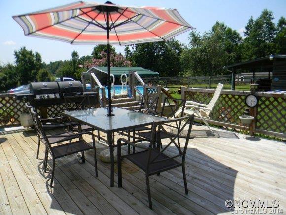 592 Scoggins Road Rutherfordton, NC 28139 - Photo 6 of 22 an outdoor space with furniture and umbrella