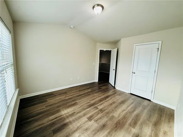 a view of an empty room and wooden floor