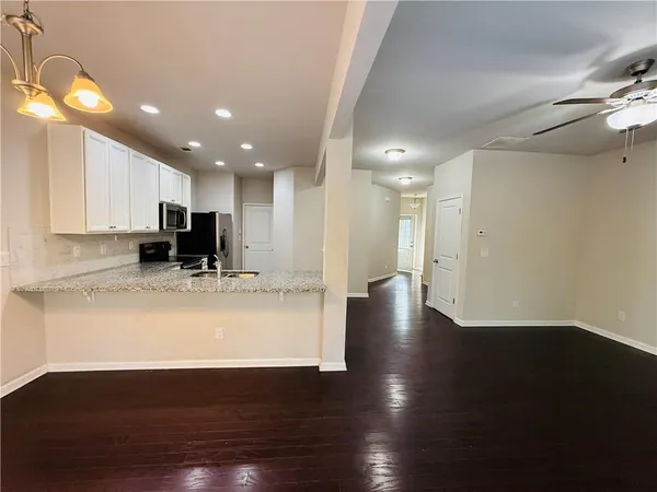 a view of kitchen with cabinets and wooden floor