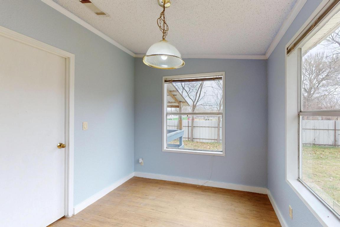 262 Highway 290 Highway East Elgin, TX 78621 - Photo 13 of 37 a view of an empty room with wooden floor and a window