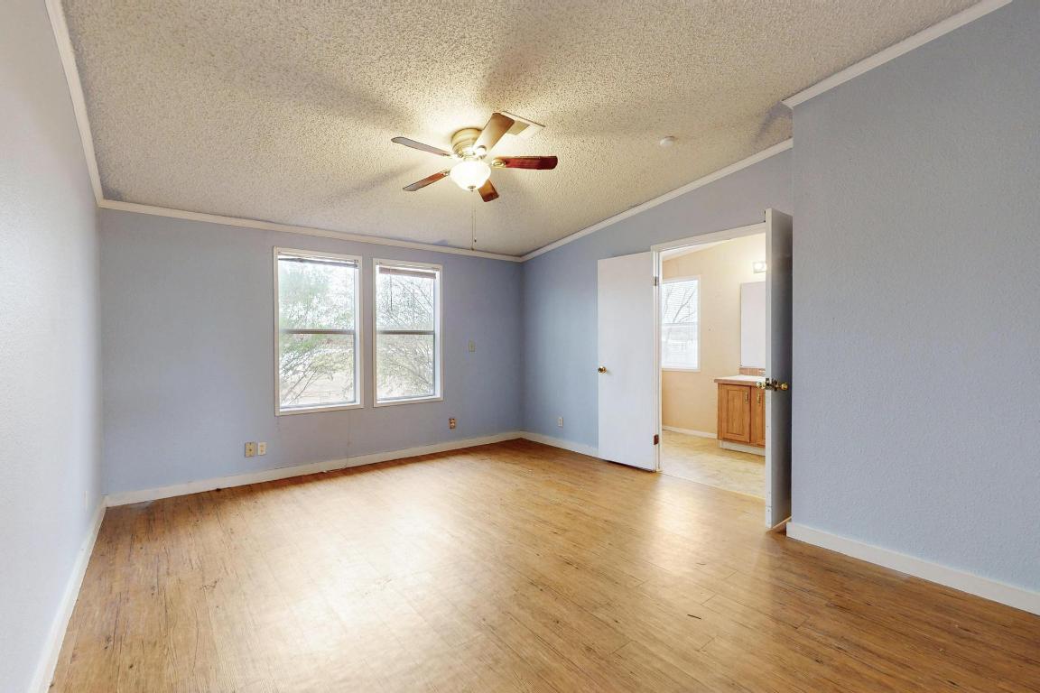 262 Highway 290 Highway East Elgin, TX 78621 - Photo 16 of 37 wooden floor in an empty room with a window