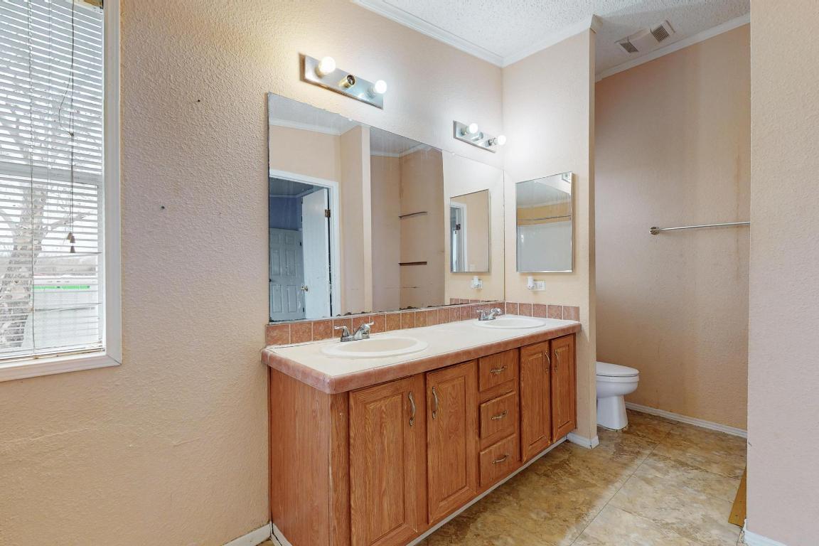 262 Highway 290 Highway East Elgin, TX 78621 - Photo 18 of 37 a bathroom with a double vanity sink toilet and a mirror