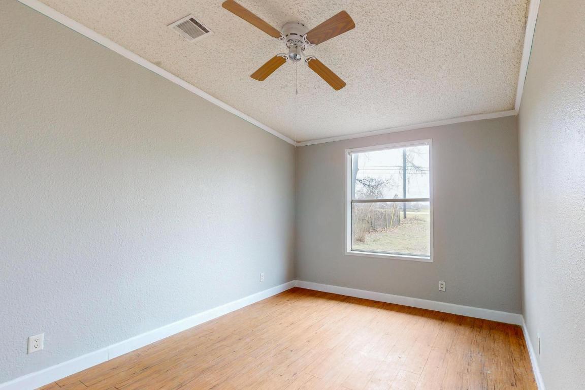 262 Highway 290 Highway East Elgin, TX 78621 - Photo 19 of 37 an empty room with a window and a fan