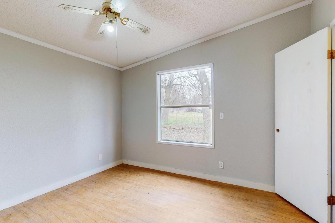262 Highway 290 Highway East Elgin, TX 78621 - Photo 21 of 37 an empty room with a window and a ceiling fan