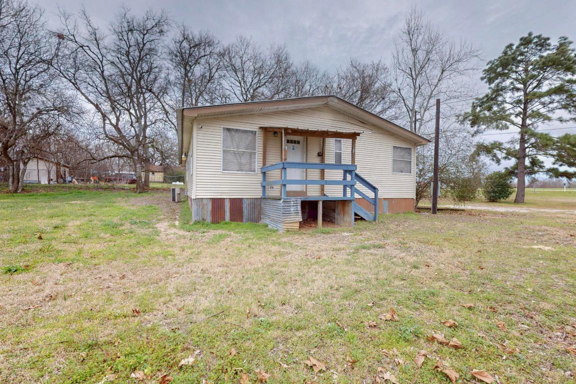262 Highway 290 Highway East Elgin, TX 78621 - Photo 24 of 37 a front view of a house with a yard and garage