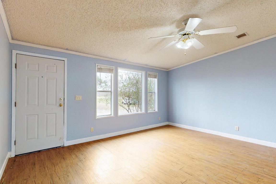 262 Highway 290 Highway East Elgin, TX 78621 - Photo 4 of 37 a view of an empty room with a window and wooden floor