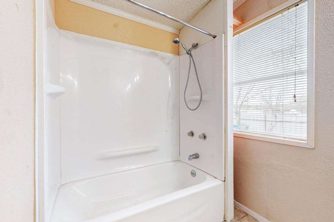 262 Highway 290 Highway East Elgin, TX 78621 - Photo 6 of 37 a bathroom with a bath tub with a shower