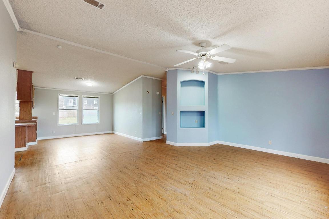 262 Highway 290 Highway East Elgin, TX 78621 - Photo 10 of 37 wooden floor in an empty room with a window