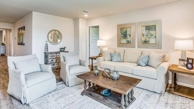a living room with furniture a rug and a window