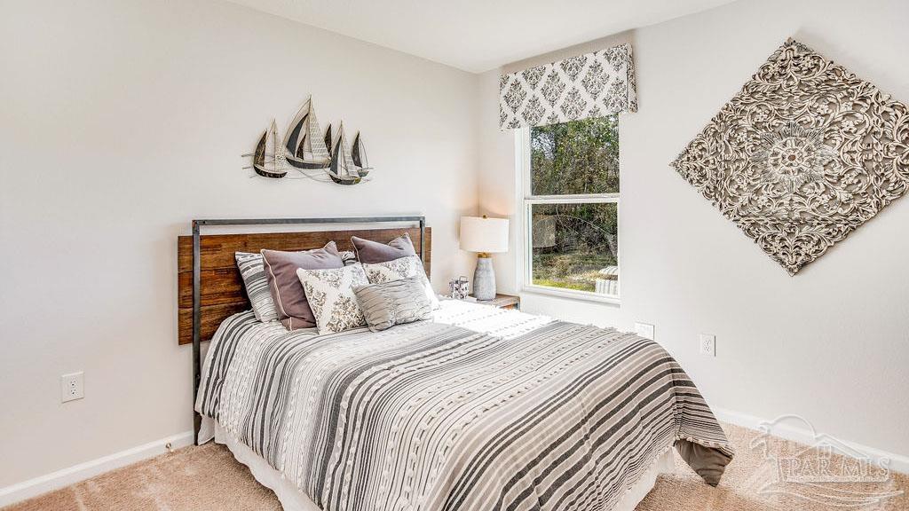 5078 Rainwater Road Milton, FL 32583 - Photo 21 of 26 a bedroom with a bed and a window