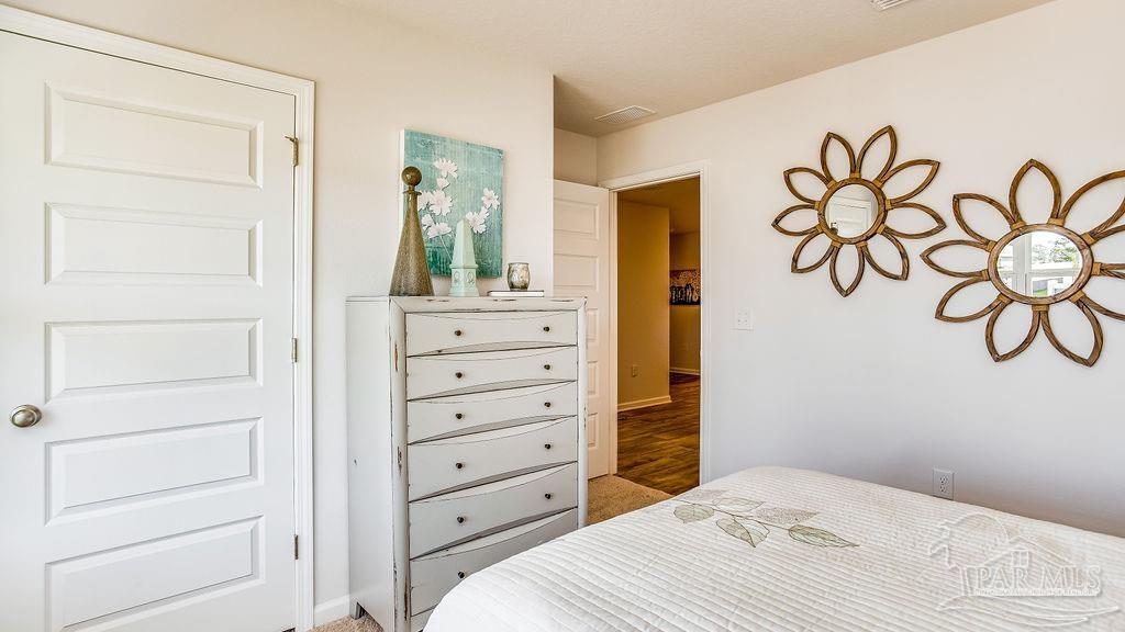 5078 Rainwater Road Milton, FL 32583 - Photo 23 of 26 a bedroom with a bed and a dresser
